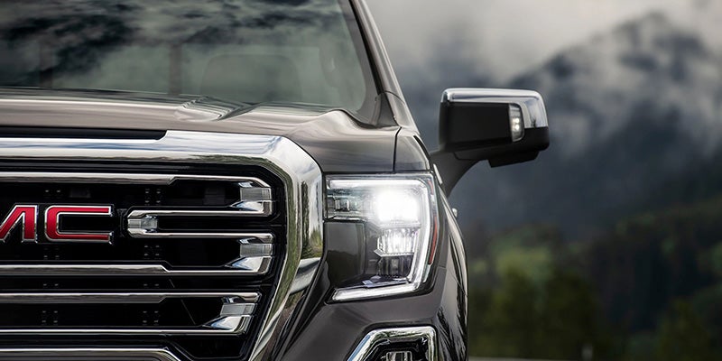Front grille of a 2020 GMC Sierra showcasing a sleek, modern design with bold lines and distinctive features.