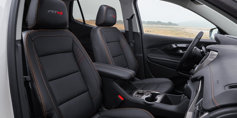 Interior view of a 2024 GMC Terrain showcasing modern design, spacious seating, and advanced technology features.