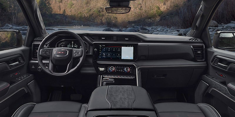 Interior view of a GMC Sierra 1500 showcasing spacious seating and modern dashboard features.