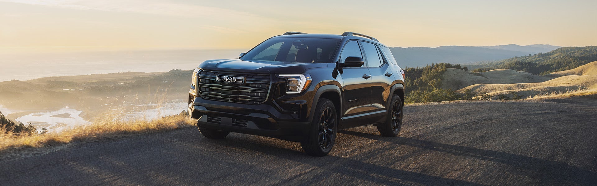 GMC Terrain SUV on a scenic mountain road.