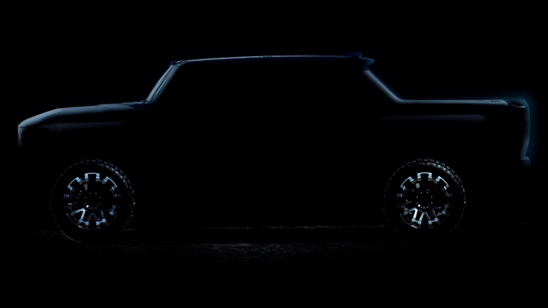 The new Ford Bronco is displayed in a dimly lit setting, highlighting its rugged design and bold silhouette.