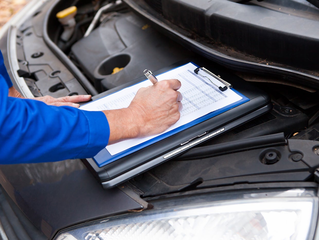 Technician checking a GMC vehicle during diagnostics